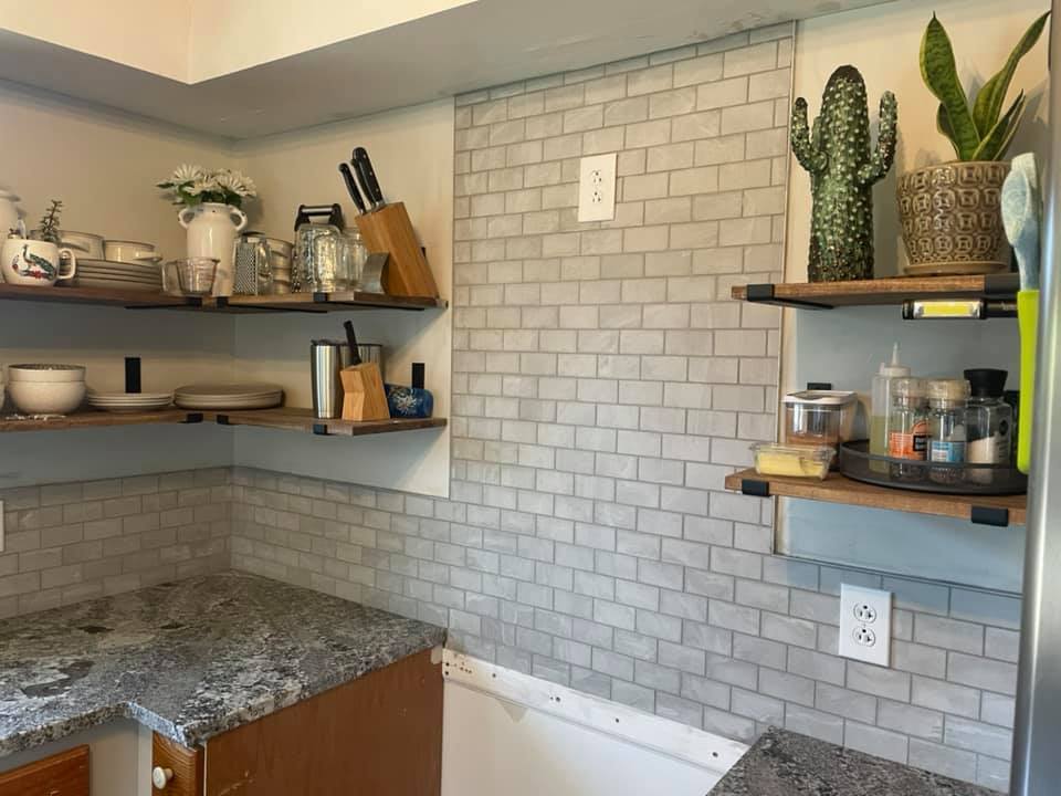 kitchen with gray tile backsplash and open shelving